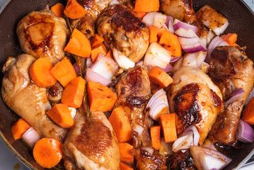 Cooking Algerian chicken in a spicy sauce with vegetables in a pan