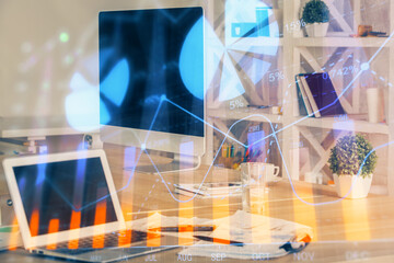 Forex market graph hologram and personal computer on background. Multi exposure. Concept of...