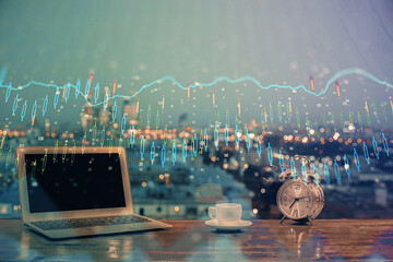 Financial graph colorful drawing and table with computer on background. Double exposure. Concept of international markets.