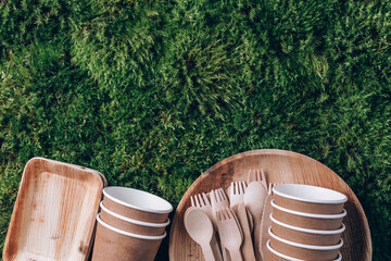Disposable tableware from natural materials. Bamboo plates, wooden spoon, fork, knife, paper cups...
