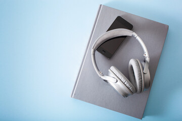 audiobook concept modern wireless headphones smartphone and book
