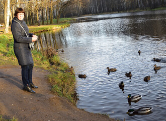 Natalia looks unhappy that someone unfamiliar might interfere with feeding the wild ducks
