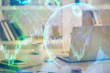 Financial graph colorful drawing and table with computer on background. Multi exposure. Concept of...