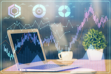 Financial chart drawing and table with computer on background. Multi exposure. Concept of...