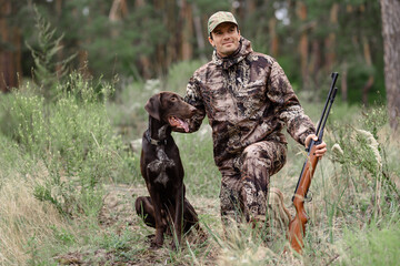 Man with Rifle Enjoying Hunt at Summer Nature.