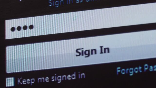 password entry. Someone enters their password on the computer screen. Log in to your account. Enter your password on the login page. macro photography of the LCD display.
