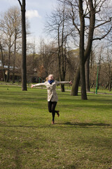 Fototapeta premium young pretty blonde girl enjoing spring nature in park, lifestyle people concept close up