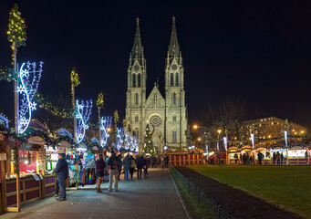 Fototapeta na wymiar Prague, Czech Republic. Christmas market at Namesti Miru (Peace Square) in front of St. Ludmila Church in night.