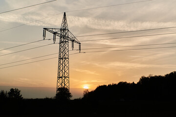 Transmission tower during sunset. Silhouette of a transmission tower during sunset. Silhouette of power lines during sunset.