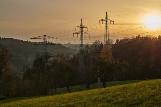 Transmission towers during sunset. Silhouette of transmissions towers during sunset. Silhouette of power lines during sunset.