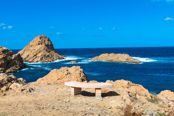 Stone bench for a view of the Mediterranean Sea, La Pietra Rock in Ile Rousse in the Balagne region...