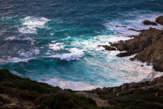 Storm waves crash on the rocky coast. Cap Corse, Corsica, France.