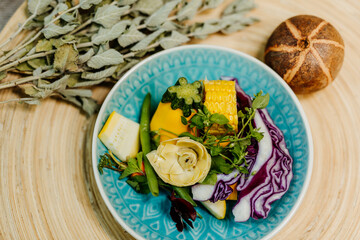 Healthy vegetarian food for a balanced diet rich in vitamins. Organic and regional products. Corn, artichokes and red cabbage