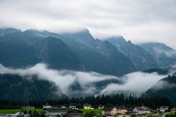 A tiny village at the foot of the mountain in the clouds