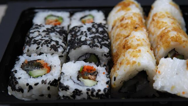 Sushi roll set with smoked eel and caviar, selective focus.
