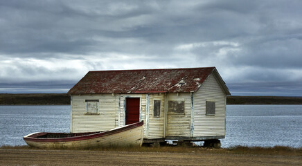Boarded up cabin with boat © Nina