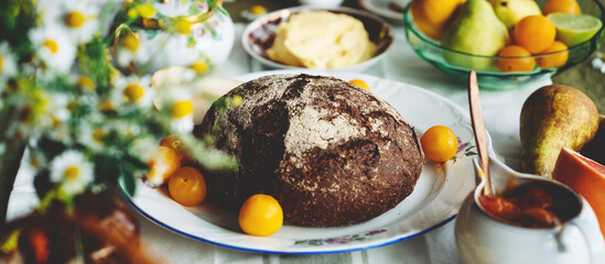 Big table with a lot of delicious food and plates. Fruits and vegetables, eggs and bread. Close-up