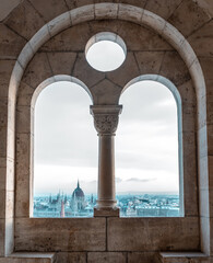 Panoramic view of Budapest through the windows of the Fisherman's Bastion at dawn in winter