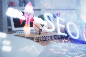 Multi exposure of woman's hands making notes with SEO icon. Concept of Search engine optimization