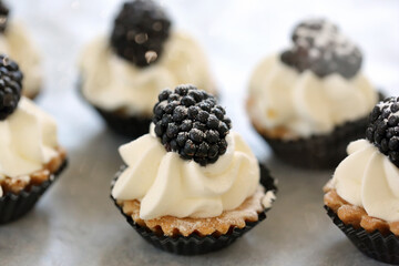 Sweet cookies with cream and blackberries
