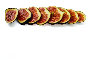 Bright juicy ripe figs on a white background cut into pieces. The concept of healthy food.