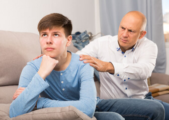 Obraz premium Portrait of angry father quarreling with his teenage son