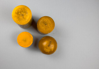 Top view closeup of four orange candles isolated on a white background