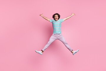 Full length photo of careless young gentleman wear casual outfit jumping legs arms sides isolated...