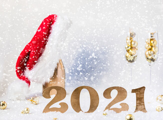 New Year's festive card with numbers 2021.Composition Champagne bottle in Santa Claus hat