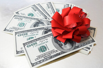 Stack of Money with Bow rotation on silver xmas background, merry christmas, happy new year, wealth...