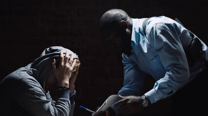 Investigation officer showing murder suspect victim photo