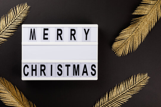 Naklejki Merry Christmas lettering on lightbox.Festive composition