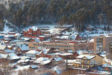 Russian Village in winter. Mountain view of the village and the village school building