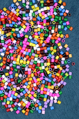 colorful beads on fabric background