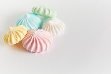 Pastel colored meringue on white background