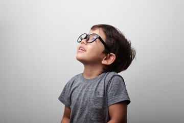 Little boy wearing big eye wear looking up