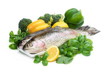 Raw fresh rainbow trout with assortment vegetables and lemons