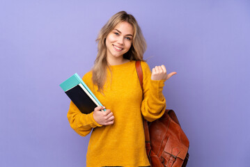 Teenager Russian student girl isolated on purple background with thumbs up gesture and smiling - obrazy, fototapety, plakaty