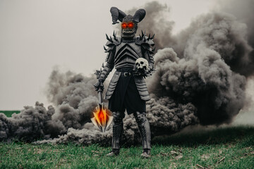 Mutant warrior stands with glowing eyes against a background of black smoke.