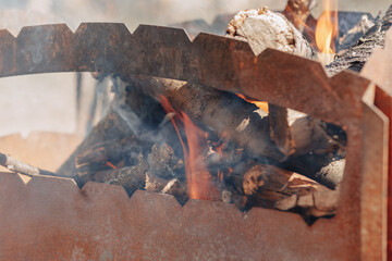 firewood in the grill. stir fires for grilling meat.