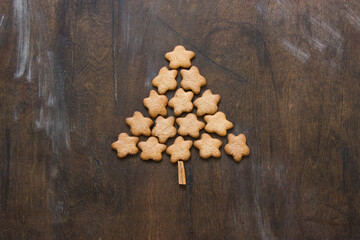 Christmas tree made of gingerbreads on a wooden background. Christmas, new year, festive, kids, food concept. free space for text