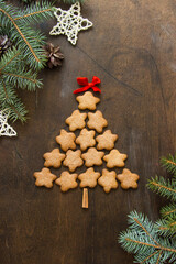 Christmas tree made of gingerbreads on a wooden background. Christmas, new year, festive, kids, food concept. free space for text