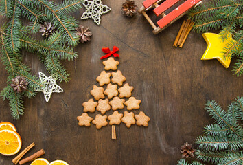 Christmas tree made of gingerbreads on a wooden background. Christmas, new year, festive, kids, food concept. free space for text
