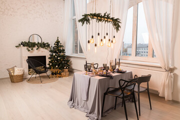Luxurious expensive light interior in a royal style decorated with table, tree and fireplace