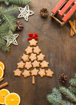 Christmas tree made of gingerbreads on a wooden background. Christmas, new year, festive, kids, food concept. free space for text