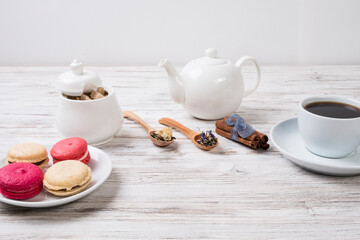 Tea, cookies and sugar on a white table.