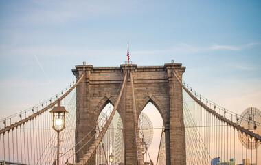 Sunset colors of Brooklyn Bridge with giant tower