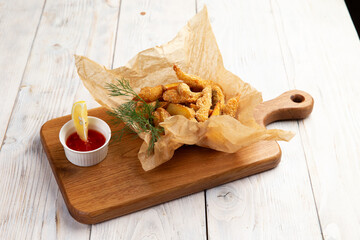 Traditional appetizer fish and chips. On a light background.