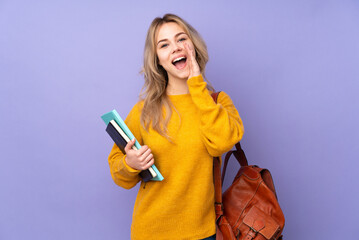 Teenager Russian student girl isolated on purple background shouting with mouth wide open