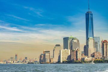 Amazing sunset colors of Lower Manhattan skyline from the ferry boat, New York City